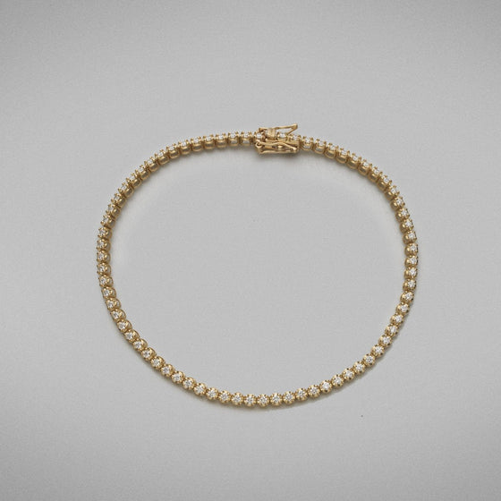 A BUNDA diamond 'Tennis' bracelet in 18ct yellow gold. The bracelet is set with round brilliant diamonds in crown settings.  Characteristics of Round Brilliant Cut Diamonds: 72 = 1.08ct, F colour, VS Clarity  Total weight: 5.89 grams