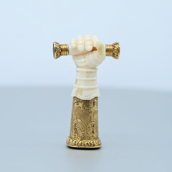 Ivory hand with gold engraved base