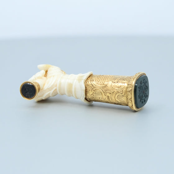 Ivory hand with gold engraved base