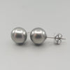 A pair of BUNDA 'Studs' in 18ct white gold. Each stud is set with a Tahitian pearl, round in shape, silver grey in colour, with clear skin and excellent lustre. Fittings are post and butterfly. Butterflies are stamped 'BUNDA'.