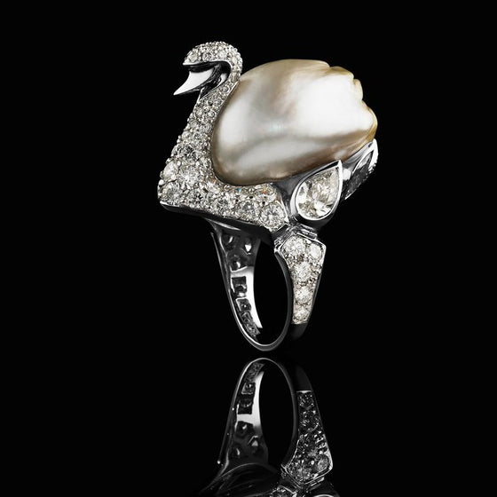 A BUNDA 'Swan' ring in platinum, featuring an exquisite, baroque Cultured South Sea Keshi Pearl, champagne in colour with a clean skin and an excellent lustre. The Swan itself features a round brilliant cut diamond pave set body with bezel set pear and marquise diamonds.  Dimensions of pearl: 15.80-21.80mm  Characteristics of pear shaped diamonds: 2 = 1.13ct, D-F colour, SI1 clarity.  Characteristics of marquise diamonds: 2 = 0.49ct, F colour, VS clarity.  Characteristics of round brilliant cut diamonds: 90