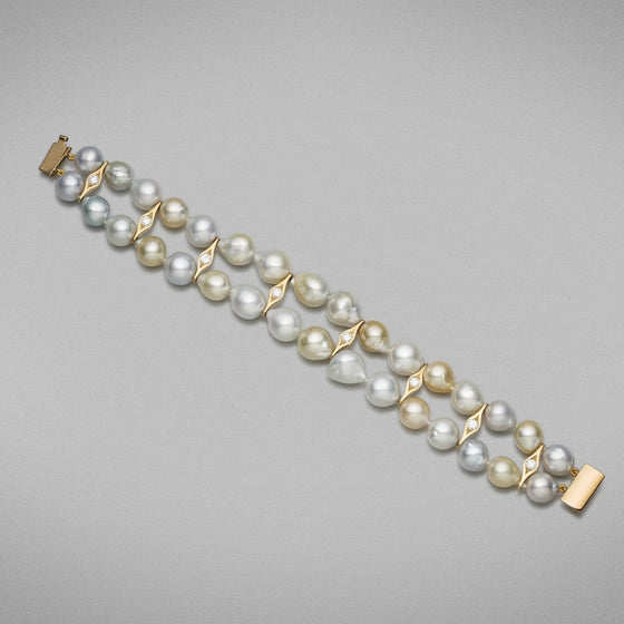 A BUNDA 'Couture' Double Row South Sea Pearl Bracelet strung with Champagne and Silver Pearls accented with 18ct Yellow Gold and Diamond fittings. The pearls measure 9.00 to 12.00 mm and have clean skin and excellent lustre and are spaced with 18ct yellow gold spacers set with round brilliant diamonds. The bracelet is closed with an 18ct yellow gold rectangular box clasp.  Total diamond weight 8 = 0.96ct. F Colour, VS Clarity