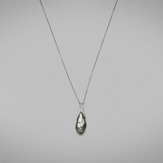 'Caelum' Cultured Tahitian Keshi pearl and Diamond Pendant in 18 carat white gold, featuring a baroque shaped Keshi pearl, set with a diamond thread-set cap that follows the curve of the pearl and is fitted with an 18 carat white gold trace chain.  Characteristics of Diamonds: 0.15cts. F Colour, VS Clarity  Total weight of pendant: 5.82 grams