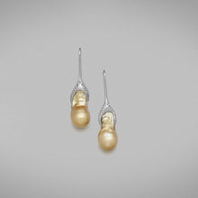  A pair of BUNDA 'Caelum' Golden Cultured South Sea pearl earrings, set with baroque shaped pearls fitted on to threadset diamond hooks in 18 carat white gold.  Dimensions of pearls: 10.00 - 11.00mm  Characteristics of diamonds: 38= 0.16ct, F colour, VS clarity.
