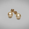 A pair of BUNDA Cultured South Sea pearl stud earrings in 18 carat yellow gold, set with round shaped pearls of clean skin and excellent lustre.  The pearls are an intense deep golden colour and measure approximately 12.90mm.  Fittings are post and butterfly.