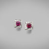 A pair of BUNDA 'Arya' Ruby and earrings in 18 carat white gold, featuring a pair of Asscher cut rubies, claw set to the centre and surrounded with thread-set round brilliant cut diamonds, with a post and butterfly fitting.  Characteristics of Ruby: 2 = 1.51ct.  Provenance: Burma (Myanmar)  Characteristics of diamonds: 24 = 0.36ct, F colour, VS clarity.