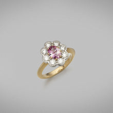  The ring is set with a 0.86ct pink spinel from Tanzania in an eight claw 18ct yellow gold setting. The centre stone is framed with eight round brilliant diamonds in platinum settings.  Total Diamond Weight: 8 x diamonds = 0.82ct. F Colour, VS Clarity  Ring weighs 6.18 grams