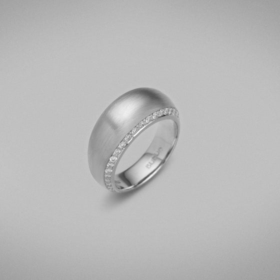 A BUNDA 'Bundova' Diamond Ring in Platinum. The ring has a high dome lined with thread-set round brilliant diamonds on both sides. Ring is stamped 'BUNDA'.  Characteristics of Round Brilliant Cut Diamonds: 50 = 0.49ct, F Colour, VS Clarity  Total weight of Ring: 15.01 grams