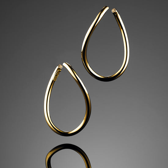 Stunning 'Bundova' Swirl hoops in 18ct yellow gold are delightfully light to wear with organic, sweeping lines. Lift your look with these dramatic earrings.
