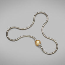  A BUNDA Cultured South Sea pearl and diamond 'Dorado' pendant in 18 carat white gold, featuring a round shaped pearl of clean skin and excellent lustre, gold in colour, on an 18 carat white gold Boa chain.  Dimensions of pearl: 1 = 15.10mm.  Characteristics of diamonds: 24 = 0.53ct, F colour, VS clarity.  Total weight: 39.33g