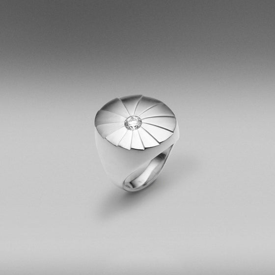 A BUNDA 'Apus' diamond ring in 18ct white gold, featuring a gypsy set round brilliant cut diamond and brushed gold finish.  Characteristics of diamond: 1 = 0.33ct, G colour, SI1 clarity.  Total Weight of Ring: 21.28g