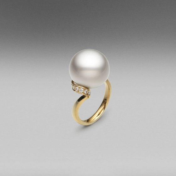A BUNDA Cultured Tahitian pearl and diamond 'Lyra' ring made in 18 carat yellow gold, featuring a round shaped pearl of clean skin and excellent lustre, Platinum in colour.  Dimensions of pearl: 15.00mm  Weight of diamonds: 22 = 0.46ct, F colour, VS clarity.  Total weight: 10.06g