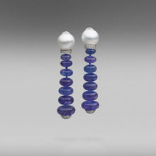  A pair of BUNDA 'Dorado' clip and post earrings in 18 carat white gold, featuring graduated, tanzanite cabochon styled beads, strung below a pair of Cultured, South Sea pearls, with a diamond set rondel and finished off with a diamond pave set cap at the base. The South Sea pearls are 12-13.00mm in size, button in shape and are white with clean skins and an excellent lustre.  Characteristics of tanzanite: 14 = 84.50ct  Characteristics of diamonds: 69 = 0.85ct, F colour, VS clarity.