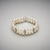 A BUNDA 'Apus' double strand bracelet, featuring Akoya pearls, strung knotted with a high polished 18ct white gold diamond set rectangular clasp, and high polished 18ct white gold diamond set spacers.  The 44 pearls are round in shape, white in colour, have excellent lustre and clean skins and range in size from 7.00 - 7.45mm  Characteristics of Additional Diamonds: 36 = 0.50ct, F Colour / VS Clarity  Clasp is stamped 'BUNDA'  Total Weight: 31.76 grams