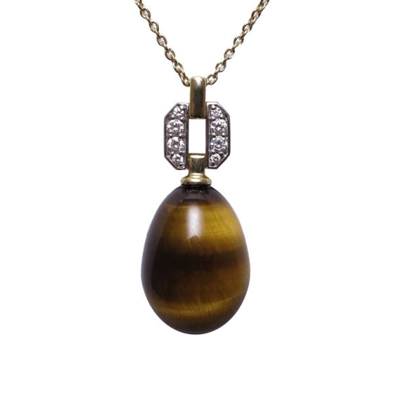 A BUNDA 'Hollywood' pendant in 18ct white and 18ct yellow gold featuring a Tigers Eye drop fitted below a threadset, round brilliant cut diamond pendant mount with an 18ct yellow gold trace chain. The tigers eye drop weighs approximately 11.50ct.  Characteristics of diamonds: 8 = 0.09ct, F colour, VS clarity.