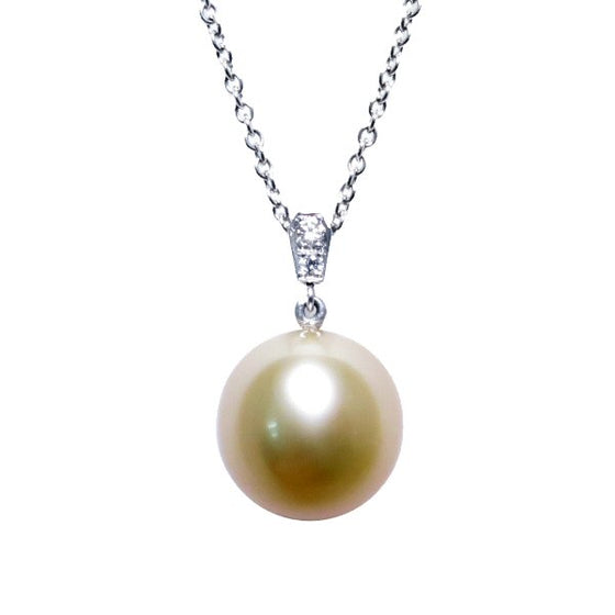 A BUNDA Cultured South Sea pearl and diamond 'Russe' pendant in 18 carat white gold, featuring a drop shaped golden pearl of clean skin and excellent lustre, on an 18 carat white gold Trace chain. Dimensions of pearl: 10.49 - 10.57mm Characteristics of diamonds: 2 = 0.03ct, F colour, VS clarity.