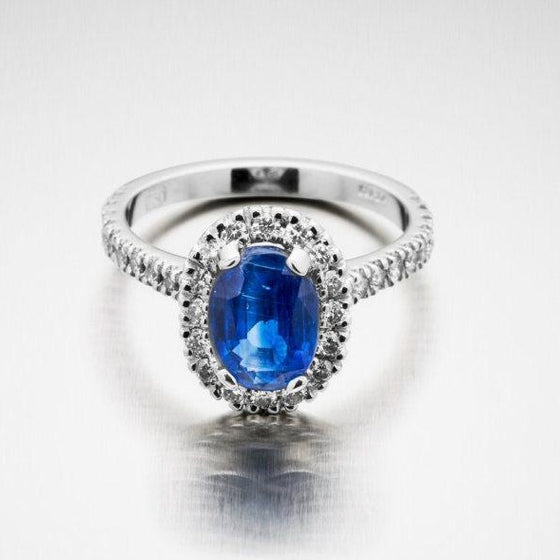 A BUNDA 'Valentin' Kyanite and diamond ring in 18 carat white gold, featuring an oval cut Kyanite, surrounded with castle set round brilliant cut diamonds to the head and shoulders.  Weight of Kyanite: 2.03ct  Characteristics of diamonds: 36 = 0.50ct, F colour, VS clarity.  Total weight of Ring: 4.48 grams.